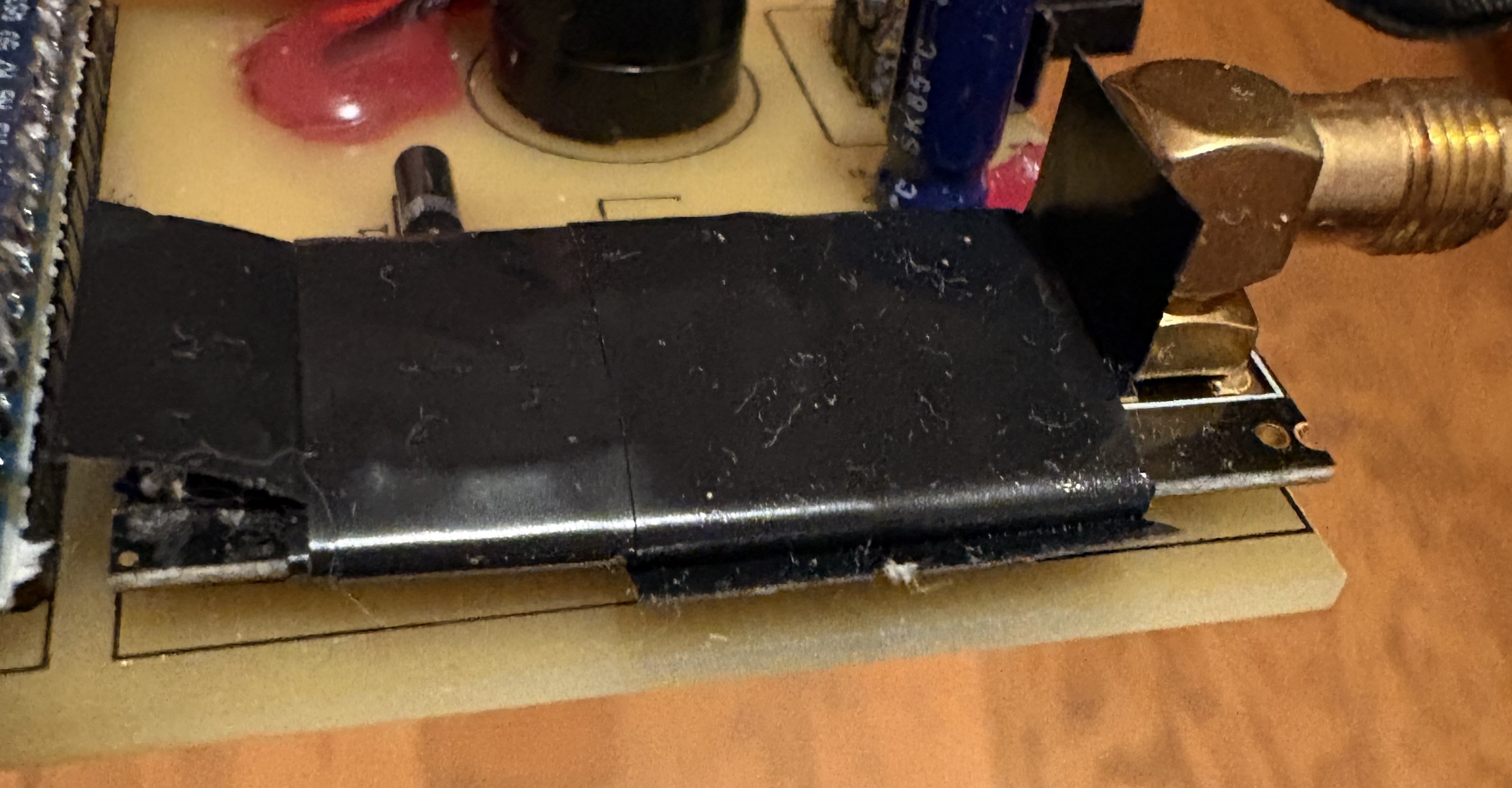 NRF24L01 module wrapped in aluminium foil grounded to the PCB — the fix that ended over a year of intermittent failures